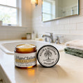 Nourish & Seal Whipped Tallow balm by Willow & Woodsman Apothecary, amber jar on bathroom counter