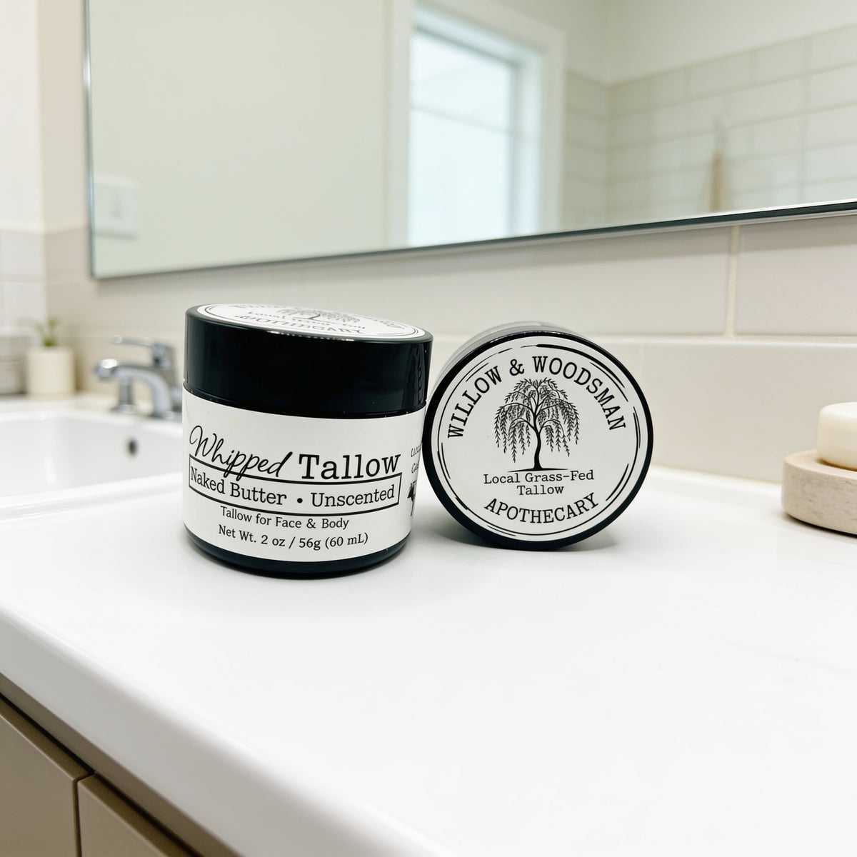 Whipped Tallow Naked Butter unscented balm by Willow & Woodsman Apothecary, 2 oz jar on bathroom counter